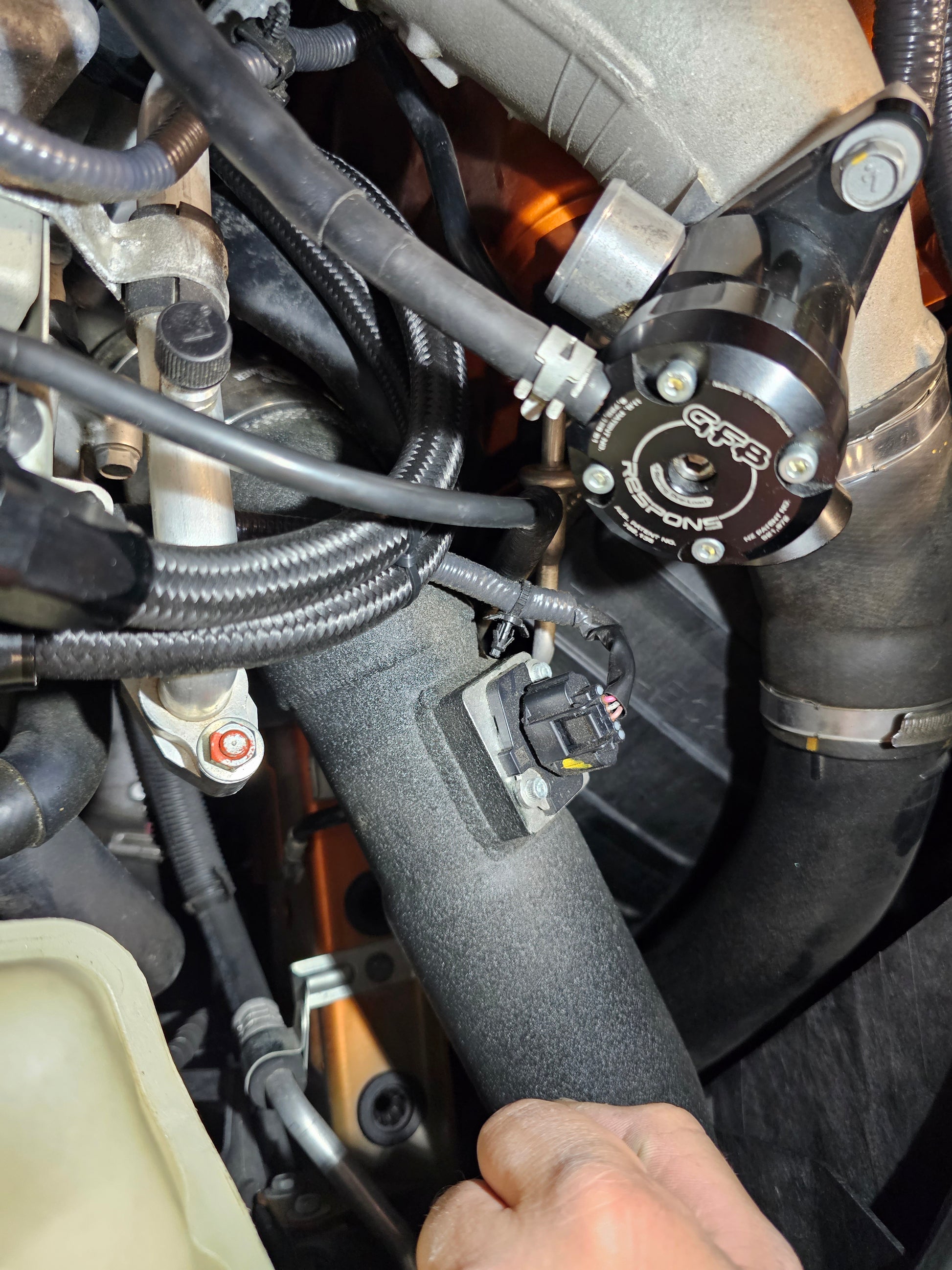 Aftermarket GFB blow off valve installed on a Nissan GTR R35 to enhance boost control and create adjustable turbo sound.