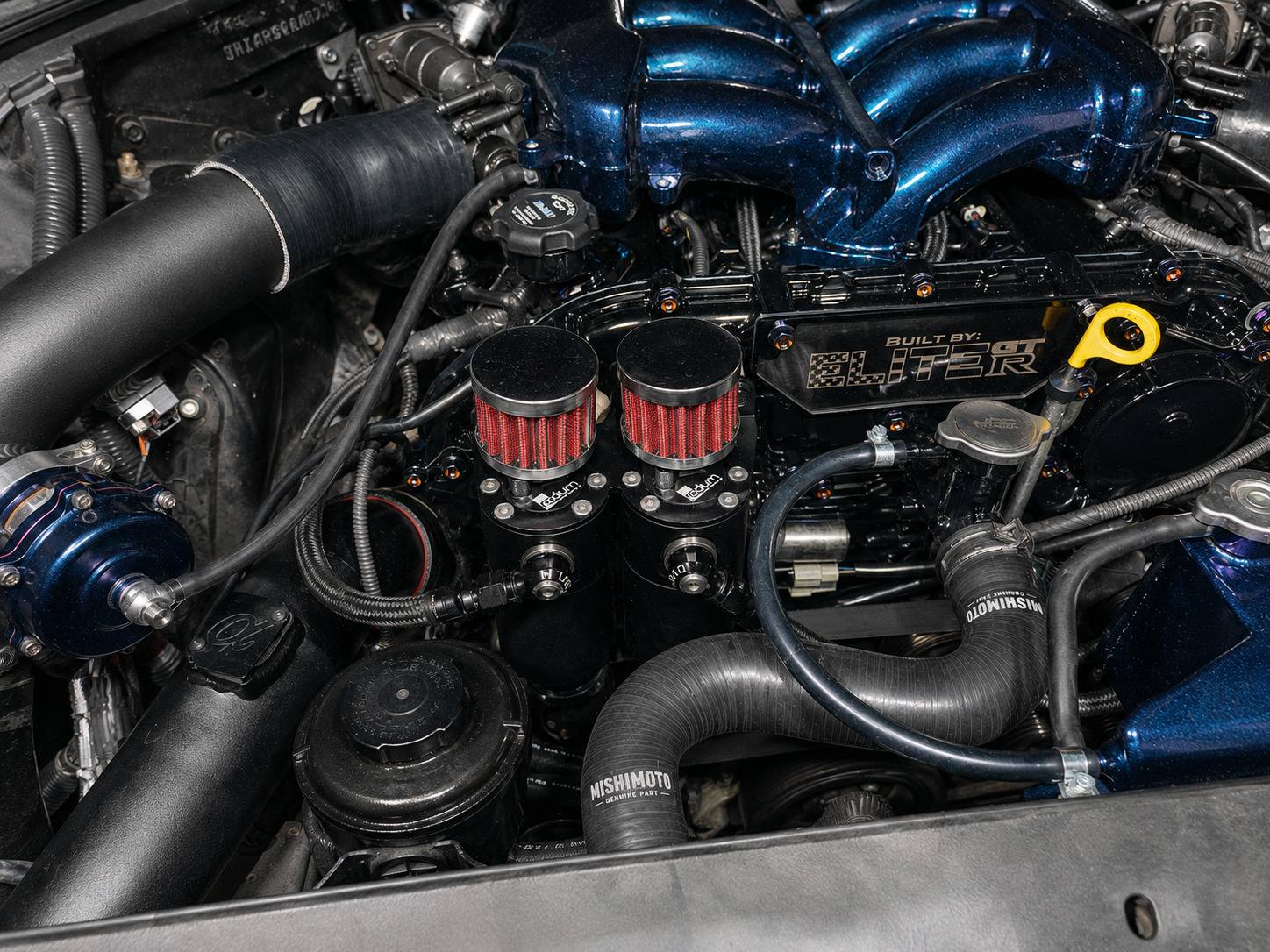 Radium catch can installed on a Nissan R35 GT-R engine bay